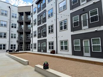Courtyard with gravel surface and surrounding balconies
